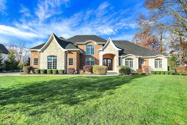 french country home featuring a front lawn