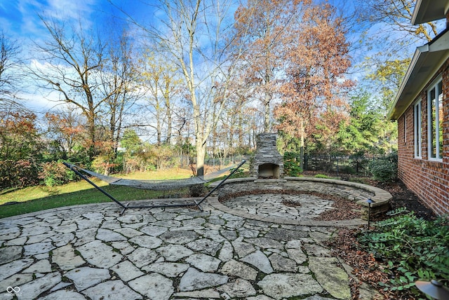 view of patio with an outdoor stone fireplace