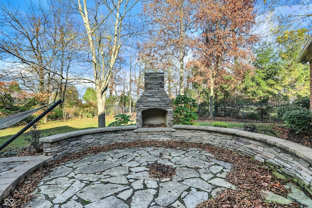 view of patio featuring an outdoor stone fireplace