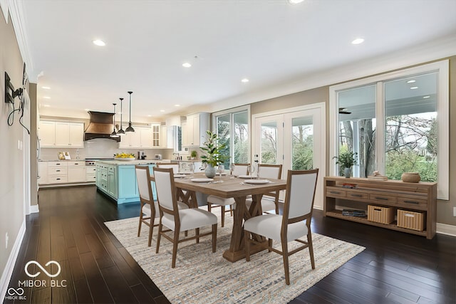 dining space featuring dark hardwood / wood-style floors, plenty of natural light, and ornamental molding