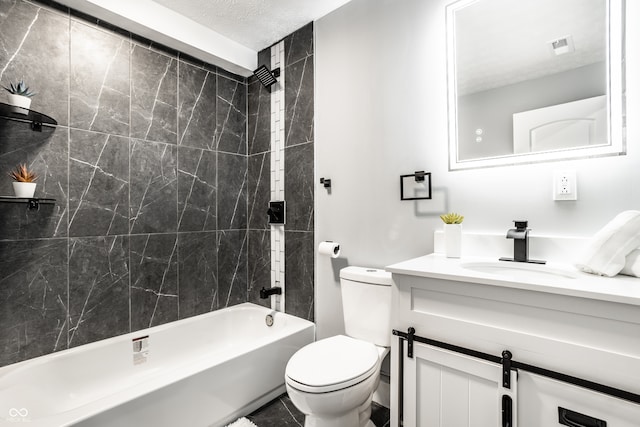 full bathroom featuring a textured ceiling, vanity, toilet, and tiled shower / bath