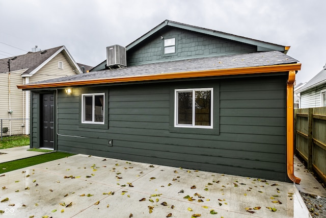 rear view of house featuring a patio and central AC