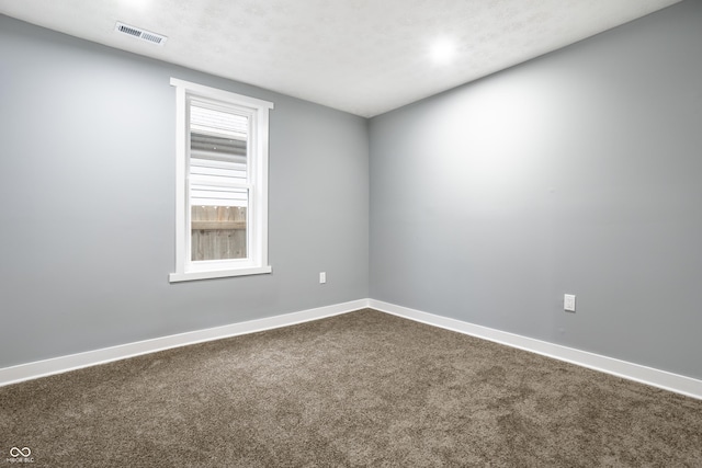 1621 Draper St, Indianapolis, IN 46203 - empty room featuring dark colored carpet and baseboards