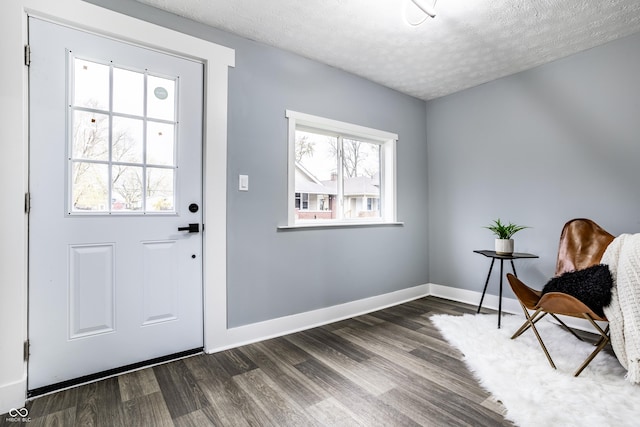 1621 Draper St, Indianapolis, IN 46203 - doorway to outside featuring dark wood finished floors, a textured ceiling, and baseboards