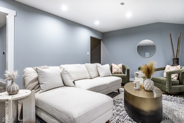 living room featuring lofted ceiling