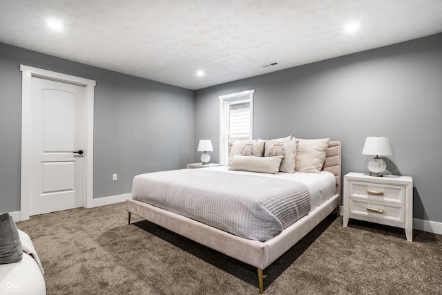 bedroom with dark carpet