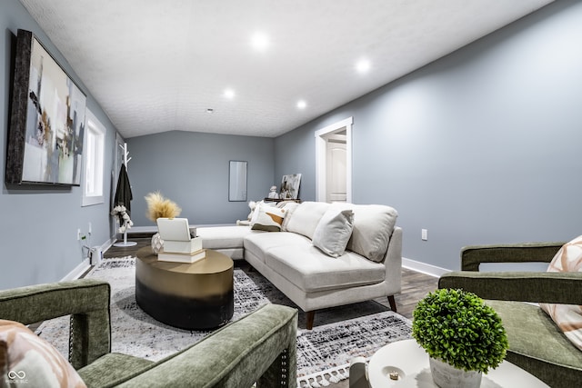 living room with wood-type flooring and vaulted ceiling