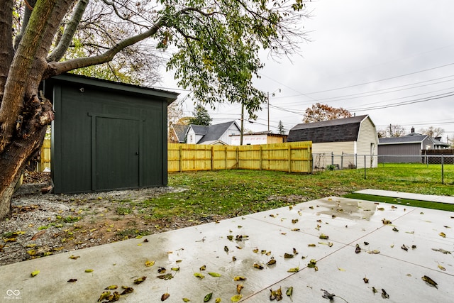 view of yard with a shed and a patio area