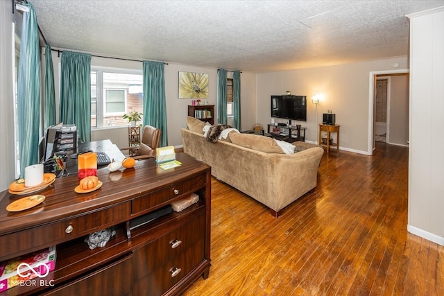 living room with wood-type flooring and a textured ceiling