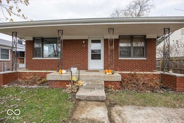 entrance to property featuring covered porch