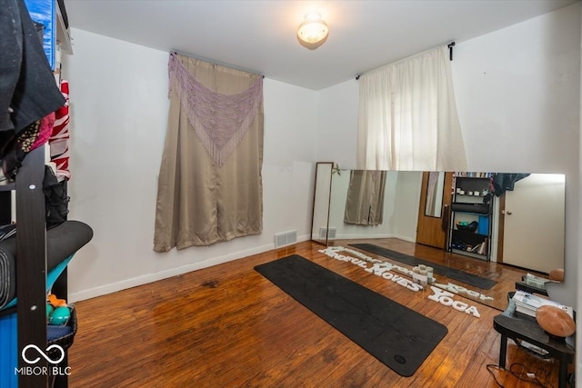 exercise room featuring hardwood / wood-style floors