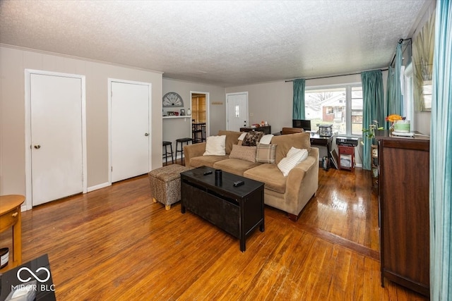 living room with hardwood / wood-style floors and a textured ceiling