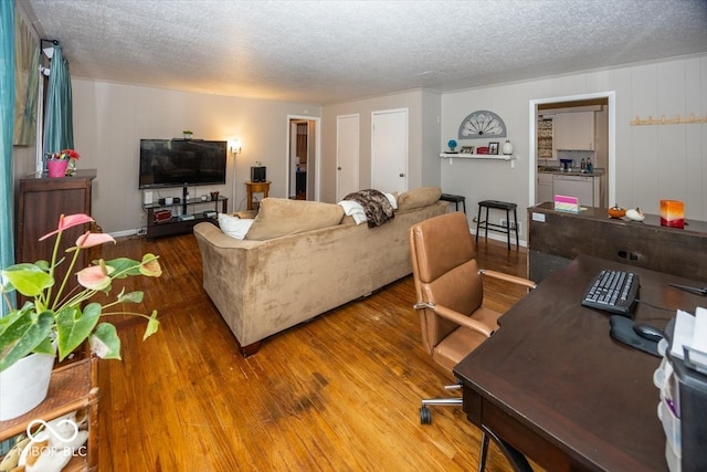 living room featuring hardwood / wood-style flooring and a textured ceiling