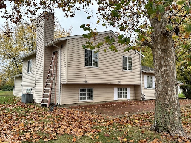 back of property with cooling unit and a patio