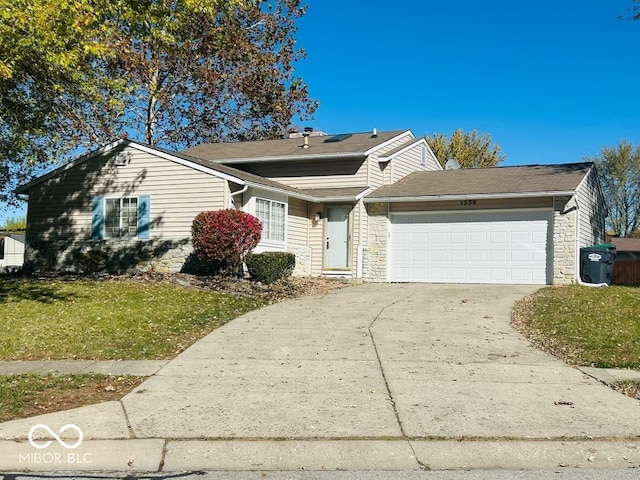 view of front of property featuring a garage and a front yard