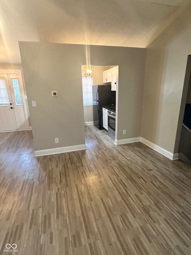 unfurnished living room with wood-type flooring