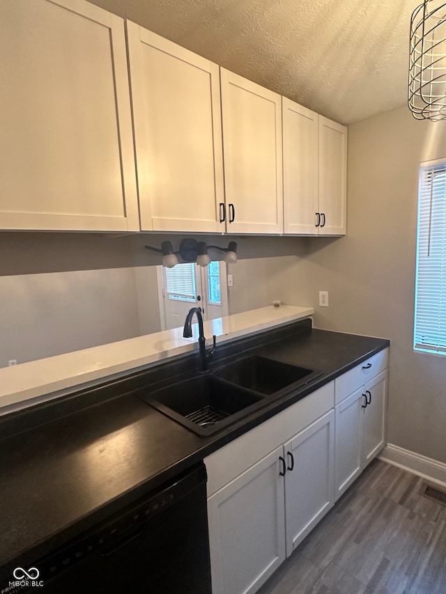 kitchen featuring white cabinetry, a textured ceiling, dark hardwood / wood-style flooring, sink, and dishwasher