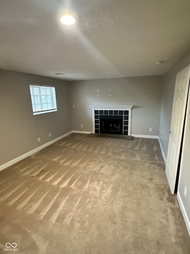 interior space featuring carpet and a tile fireplace