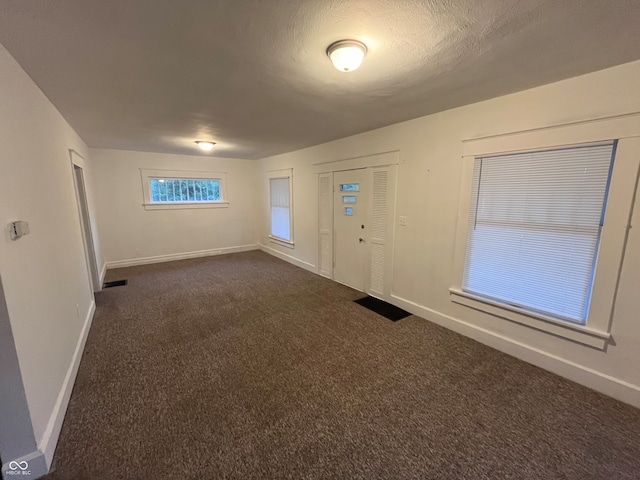 view of carpeted foyer entrance