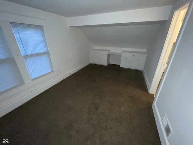 interior space featuring built in desk and dark carpet