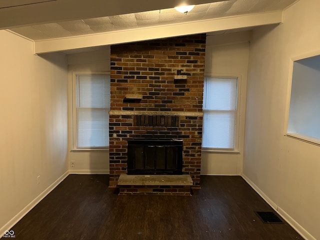 unfurnished living room with dark wood-type flooring, vaulted ceiling, and a brick fireplace