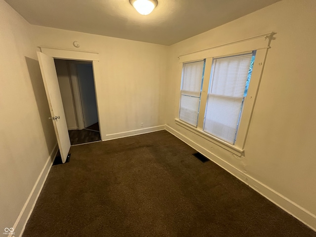 empty room with dark carpet