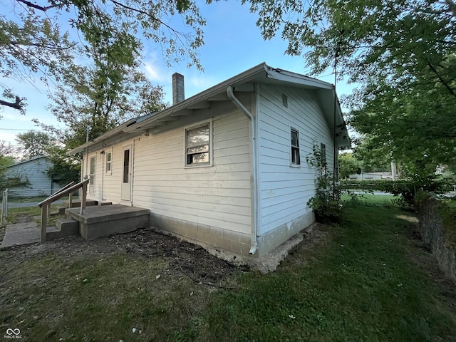 view of property exterior with a lawn