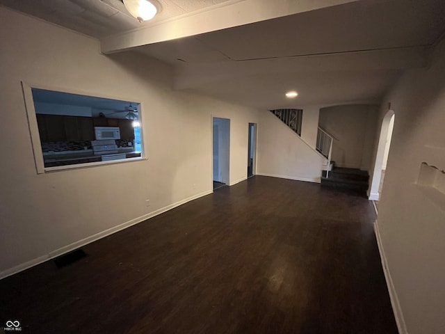 interior space with dark wood-type flooring and ceiling fan