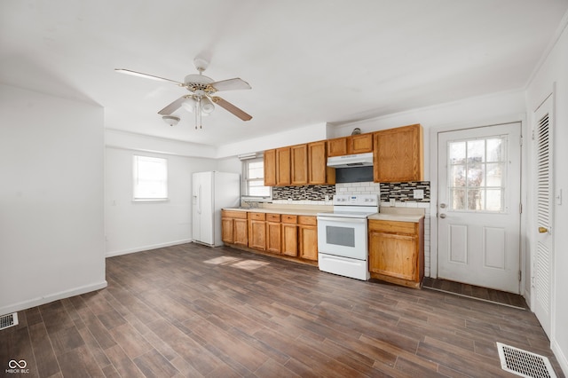 kitchen with dark hardwood / wood-style flooring, ceiling fan, white appliances, and decorative backsplash