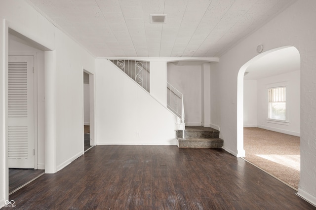 unfurnished living room featuring dark wood-type flooring