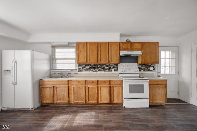 kitchen featuring tasteful backsplash, crown molding, sink, and white appliances