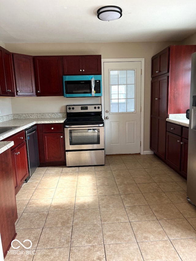 kitchen with appliances with stainless steel finishes and light tile patterned flooring