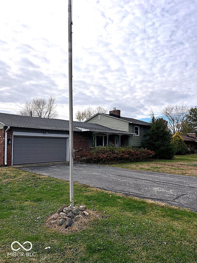 ranch-style home featuring a garage and a front yard