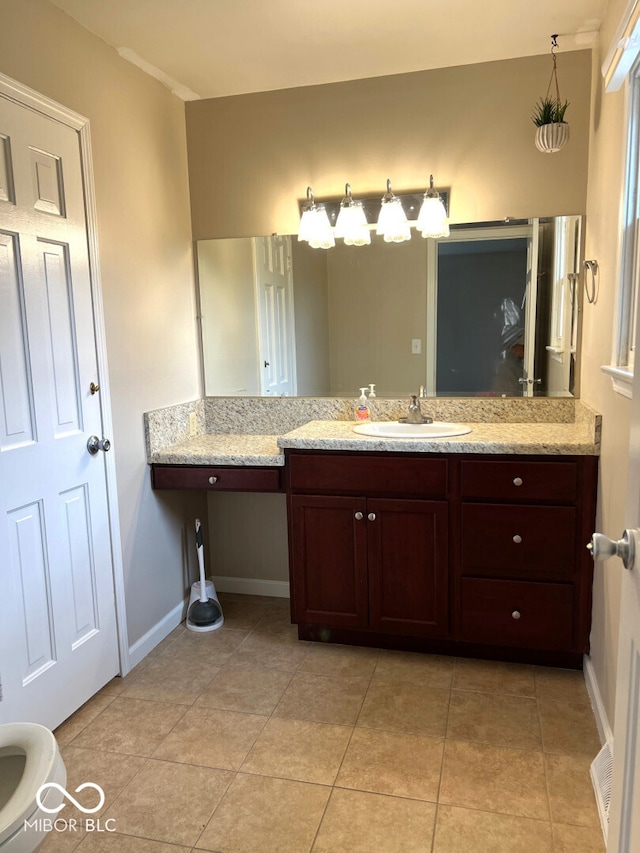 bathroom featuring tile patterned flooring and vanity