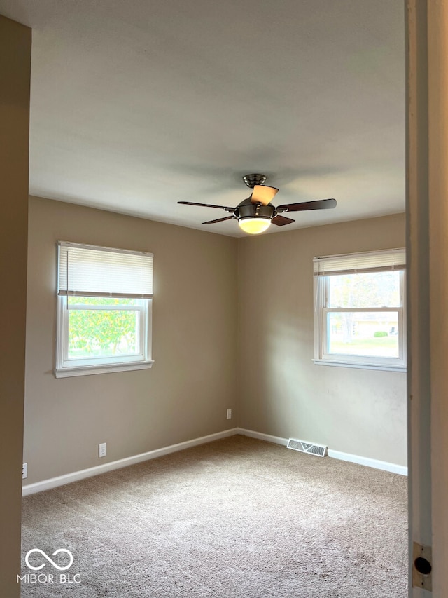 spare room with carpet and ceiling fan