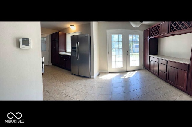 kitchen with light tile patterned flooring, stainless steel fridge, and french doors