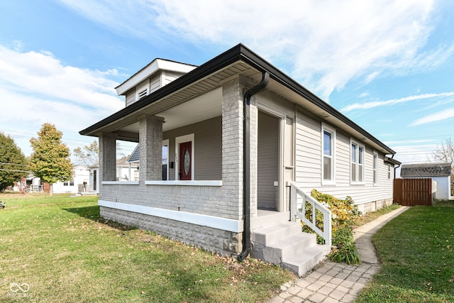 view of property exterior featuring a yard and a porch