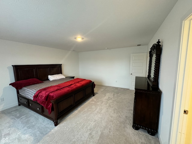 carpeted bedroom featuring a textured ceiling