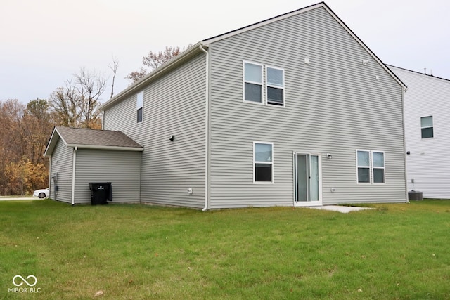 rear view of property with a lawn