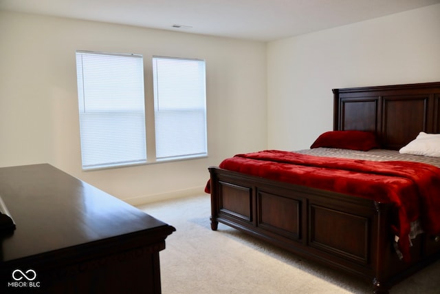 bedroom with light colored carpet