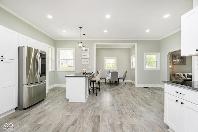 408 W 11th St, Anderson, IN 46016 - kitchen featuring smart refrigerator, a breakfast bar, baseboards, white cabinets, and arched walkways
