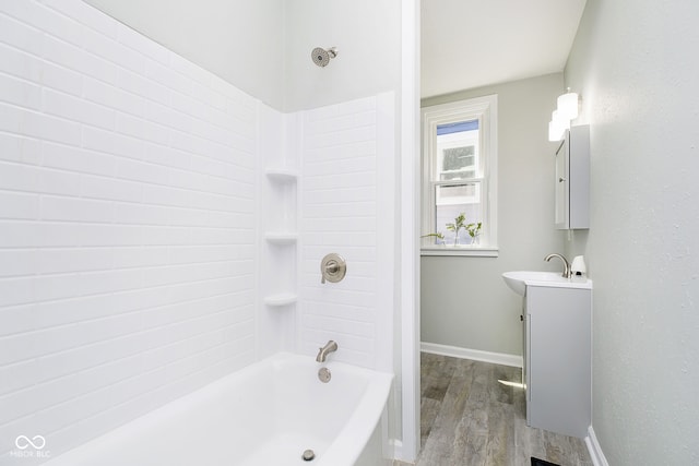 bathroom with hardwood / wood-style floors, vanity, and bathtub / shower combination