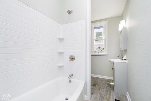 408 W 11th St, Anderson, IN 46016 - bathroom with vanity, wood finished floors, baseboards, and shower / tub combination