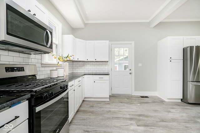 kitchen with light hardwood / wood-style floors, appliances with stainless steel finishes, tasteful backsplash, beam ceiling, and white cabinets