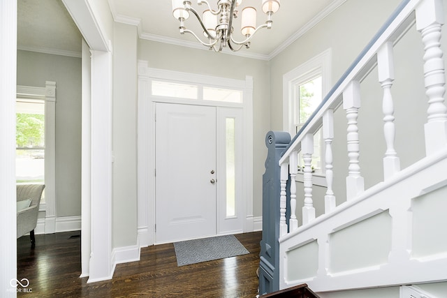 foyer featuring a chandelier, dark hardwood / wood-style floors, and crown molding