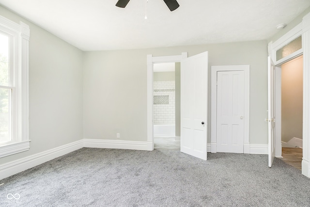 unfurnished bedroom with ceiling fan and carpet