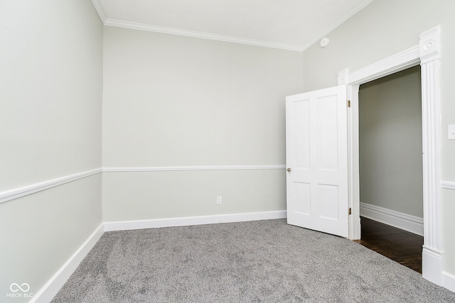 carpeted spare room featuring ornamental molding