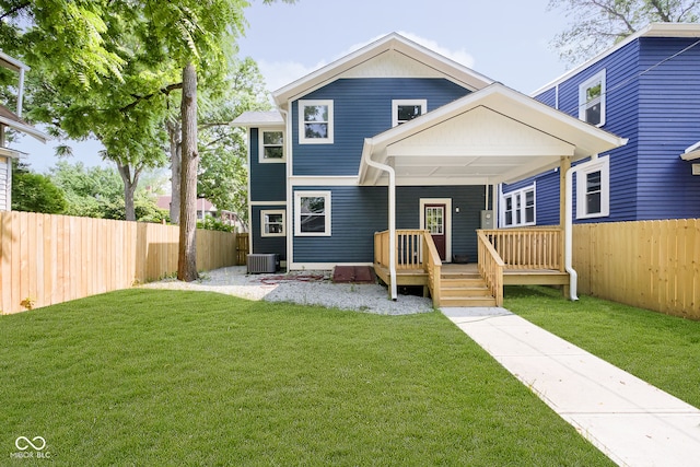 view of front of property with cooling unit, a front yard, and a deck