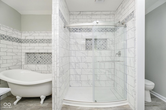 408 W 11th St, Anderson, IN 46016 - bathroom with a freestanding bath, toilet, a shower stall, and baseboards