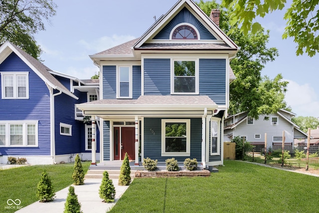 408 W 11th St, Anderson, IN 46016 - view of front facade with a chimney, a porch, and a shingled roof